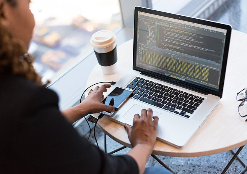 employee typing in his laptop